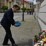Zastępca prezydenta Przemysław Tuchliński kładzie znicz pod pomnikiem