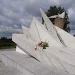 Pomnik Obrońcom Miasta, na nim leżący wieniec z biało-czerwonych kwiatów