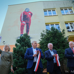 Zaproszeni goście trzymają w dłoniach fragmenty przeciętej wstęgi