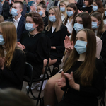 Uczniowie siedzą i oglądają uroczystość
