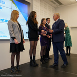Prezydent Tadeusz Truskolaski gratuluje studentce wręczając list gratulacyjny oraz nagrodę