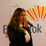 Młoda kobieta przemawia przez mikrofon 