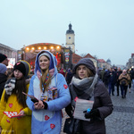 Trzy młode wolontariuszki stoją na Rynku Kościuszki