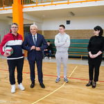Prezydent Tadeusz Truskolaski wraz z nauczycielem oraz uczniami na sali gimnastycznej w I LO