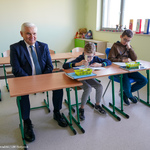 Prezydent Tadeusz Truskolaski siedzi w ławce z dwójką uczniów