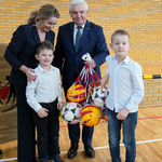 Prezydent Tadeusz Truskolaski, kobieta oraz dwóch chłopców trzymają siatkę wypełnioną piłkami 