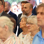 Goście wydarzenia stoją pod namiotem 