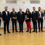 Uczestnicy konferencji stoją obok siebie.