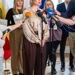 Kobieta mówi do mikrofonu, w tle inni uczestnicy konferencji.