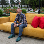 Prezes Fundacji Białystok Biega Grzegorz Kuczyński siedzi na żółtej kanapie w parku Różanka.