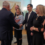 Prezydent Tadeusz Truskolaski podaje dłoń mężczyźnie, obok stoją inni uczestnicy wydarzenia.
