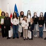 Zastępca prezydenta Tomasz Klim stoi z grupą nagrodzonych osób.